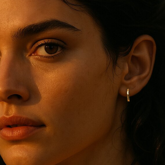 Gold hoop earrings on ear of model